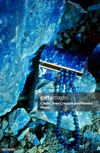 Chain and a jewellery box made of Lapis Lazuli lie on a raw Lapis Lazuli rock in the Flores de Los Andes mine, located at 3,700 meter high in the...