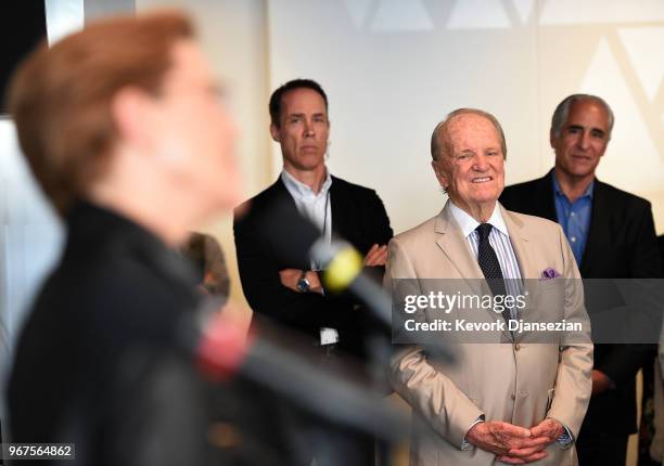 George Stevens, Jr., filmmaker and founder of the American Film Institute, listen to Anette Bening's speech during a reception in celebration of a...