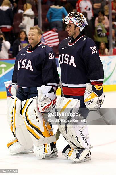 Goalies Tim Thomas and Ryan Miller of the United States skate off the ice after team USA won 3-1 against Switzerland during the ice hockey men's...