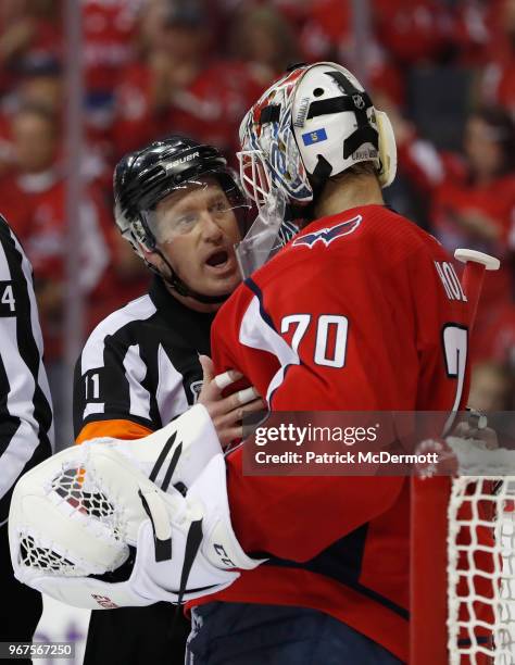 Referee Kelly Sutherland talks with goaltender Braden Holtby of the Washington Capitals during the second period of Game Four of the 2018 NHL Stanley...