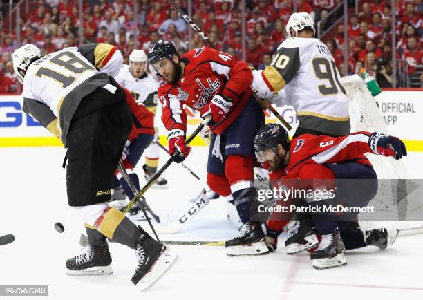 Tom Wilson of the Washington Capitals clears the puck as teammate Michal Kempny defends against the Vegas Golden Knights during the second period of...