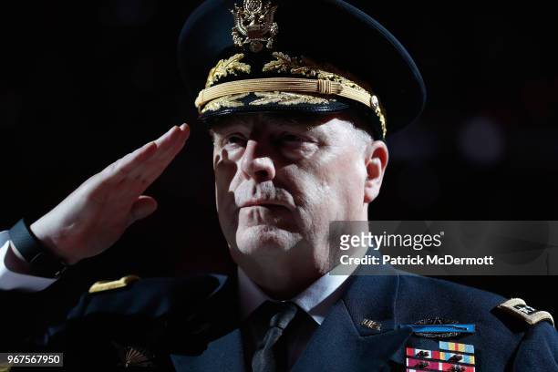 General Mark A. Milley, Chief of Staff of the United States Army, stands on the ice during the national anthem before Game Four of the 2018 NHL...