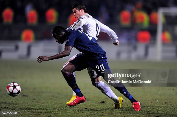 Cristiano Ronaldo of Real Madrid is tackled by Aly Cissokho of Lyon during the UEFA Champions League round of 16 first leg match between Lyon and...