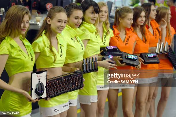Show girls display various computer products during Computex 2018 at the Nangang Exhibition Center in Taipei on June 5, 2018.