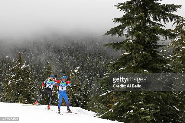 Evgeny Ustyugov of Russia is followed by Andreas Birnbacher of Germany during the Men's Biathlon 12.5km Pursuit on day 5 of the 2010 Vancouver Winter...