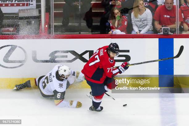 Washington Capitals right wing T.J. Oshie looks to pass as Vegas Golden Knights defenseman Colin Miller falls to the ice behind the play during game...