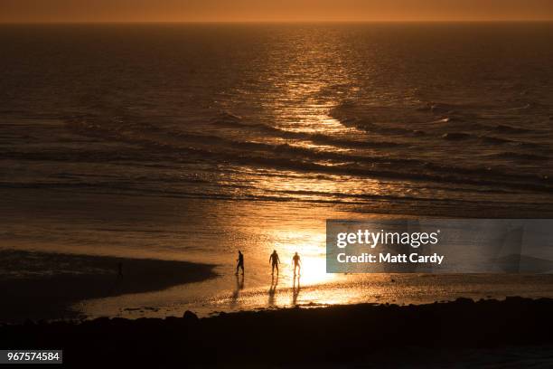 People walk on the Gold Beach at Ouistreham viewed from the deck of the ferry from Portsmouth to Caen as it travels to Normandy in France on June 3,...