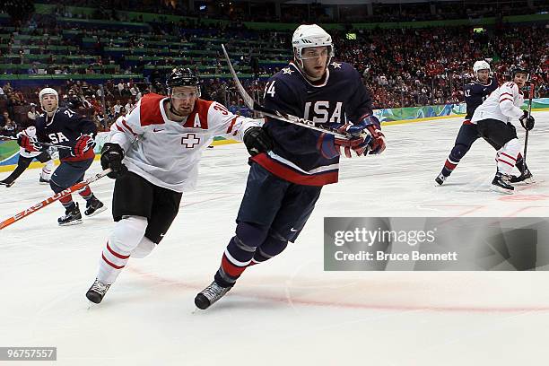 Bobby Ryan of the United States skates ahead of Mathias Seger of Switzerland during the ice hockey men's preliminary game on day 5 of the Vancouver...