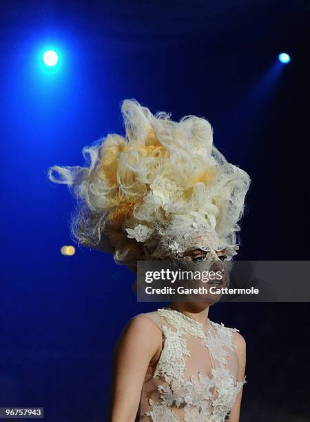 Lady Gaga walks onto te stage at The Brit Awards 2010 at Earls Court on February 16, 2010 in London, England.