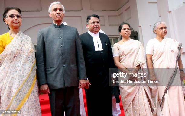 Delhi Lt Governor Tejendra Khanna with his wife Uma Khanna, new Chief Justice of Delhi High Court Ajit Prakash Shah with his wife and Delhi Chief...