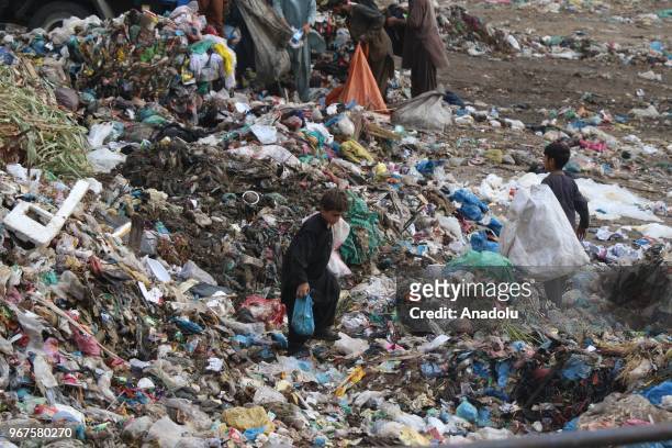 Children collect usable items from a dump site on the World Environment Day in Karachi, Pakistan on June 5, 2018. World Environment Day is celebrated...
