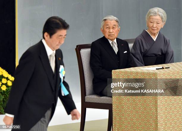 Japan's emperor Akihito and empress Michiko watch the speech of Prime Minister Shinzo Abe, left, during the 72th anniversary ceremony of the end of...