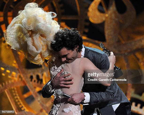 Lady Gaga accepts her award for 'Best International Album' from Mika on stage at The Brit Awards 2010 at Earls Court on February 16, 2010 in London,...