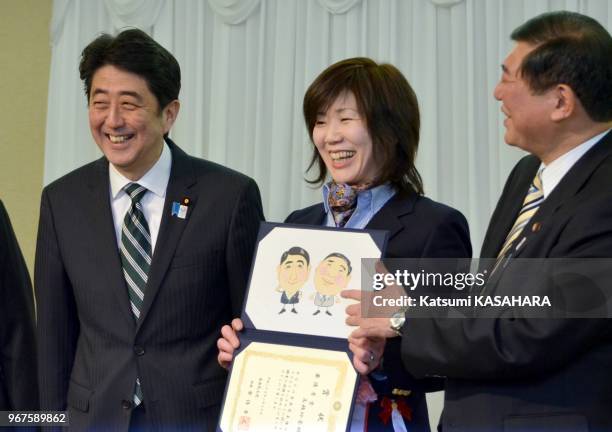 Japanese prime minister and president of the Liberal Democratic Party, Shinzo Abe and Shigeru Ishiba, chief secretary of his party show their...