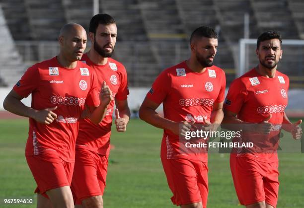 Tunisia's defender Yohan Benalouane, defender Hamdi Nagguez, defender Syam Ben Youssef, and defender Oussama Haddadi take part in a training session...