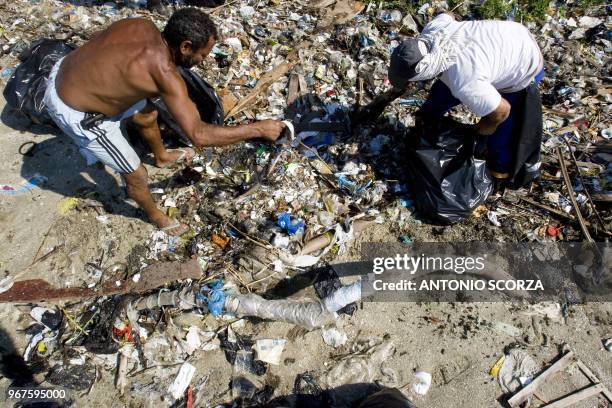 Brazilian fishermen collect plastic waste at Catalao Beach, inside the Guanabara bay, May 6 in Rio de Janeiro, Brazil. Some 288 fishermen are working...