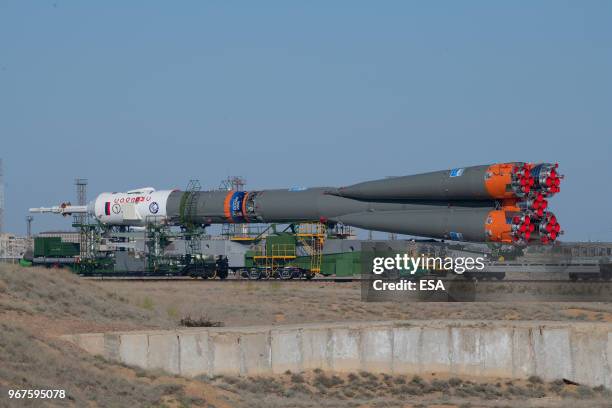 In this handout image provided by ESA, A Soyuz-FG rocket booster carrying the Soyuz MS-09 spacecraft being transported from an assembling facility to...