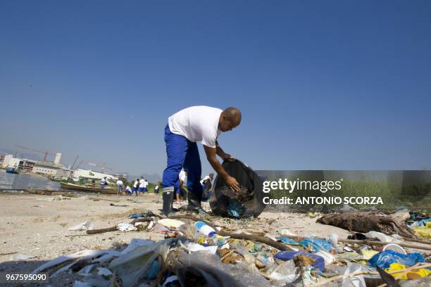 Brazilian fisherman collects plastic waste at Catalao Beach, inside the Guanabara bay, May 6 in Rio de Janeiro, Brazil. Some 288 fishermen are...