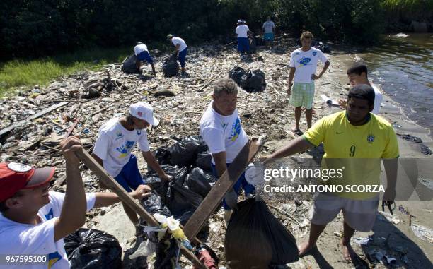 Brazilian fisherman weights part of the plastic garbage removed from Catalao Beach, inside the Guanabara bay, May 6 in Rio de Janeiro, Brazil. Some...