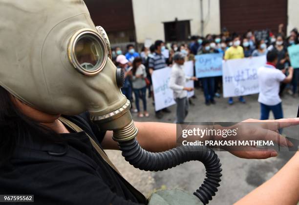 Nepali environmental activist takes part in a rally demanding clean air and dust free roads during a protest marking the 'World Environment Day' in...