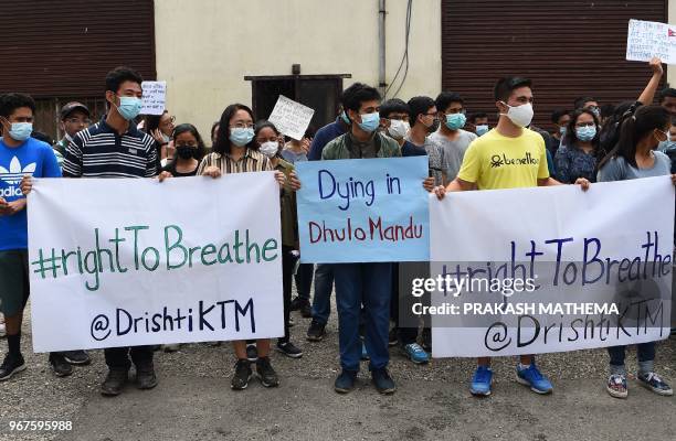Nepali environmental activists take part in a rally demanding clean air and dust free roads during a protest marking the 'World Environment Day' in...