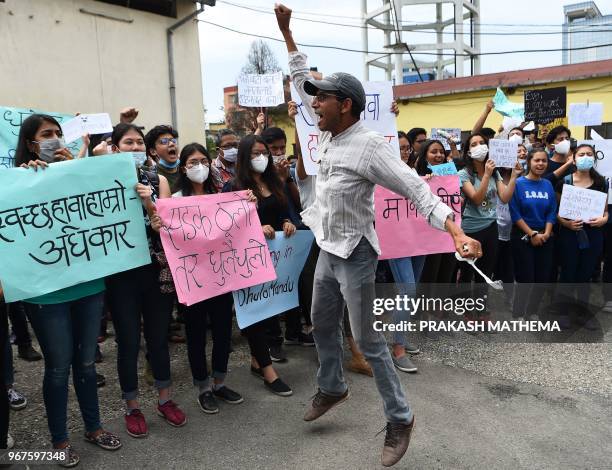 Nepali environmental activists take part in a rally demanding clean air and dust free roads during a protest marking the 'World Environment Day' in...