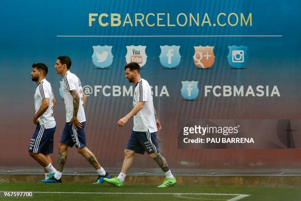 Argentina's forward Sergio Aguero , Argentina's midfielder Angel Di Maria and Argentina's forward Lionel Messi arrive for a training session at the...
