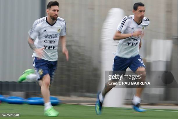 Argentina's midfielder Angel Di Maria and Argentina's forward Lionel Messi sttend a training session at the FC Barcelona 'Joan Gamper' sports centre...