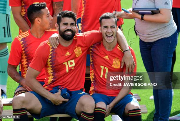 Spain's forward Diego Costa and Spain's forward Lucas Vazquez laugh as they pose for the official squad photo before a training session at Las Rozas...