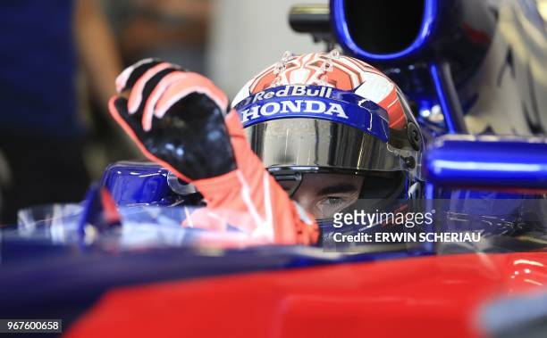 Moto GP Spanish rider Marc Marquez sits on a Formula One racecar during a testdrive in Spielberg, Austria on June 5, 2018. / Austria OUT