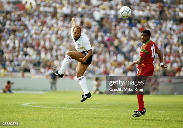 Ray Wilkins of England and Mustafa Merry of Morocco in action during