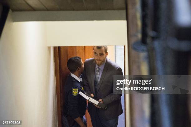 Henri Van Breda walks towards the Western Cape High Court, in Cape Town on June 5 to hear the sentence in his trial for the alleged killing of his...