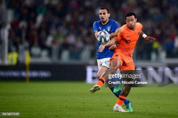 Davide Zappacosta of Italy and Memphis Depay of Netherlands compete for the ball during the International Friendly football match between Italy and...