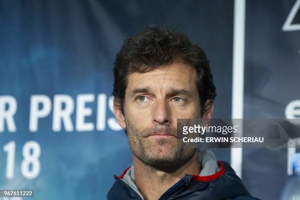Former Australian Formula One driver Mark Webber attends a press conference after Moto GP Spanish rider Marc Marquez did a testdrive on a Formula One...