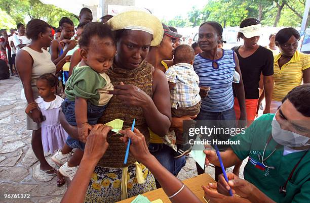 In this handout image provided by the United Nations Stabilization Mission in Haiti , Cuban doctors administer vaccinations for Tetnus and Dyptheria...