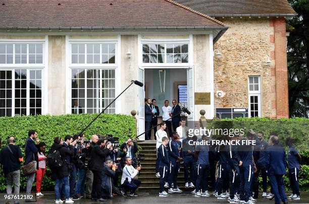France's players gather to meet French President Emmanuel Macron as he visits the team's training grounds in Clairefontaine-en-Yvelines, southwest of...