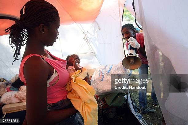 In this handout image provided by the United Nations Stabilization Mission in Haiti , Elvire Constant, goes tent by tent with a megaphone to tell...