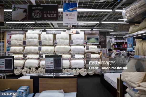 Member of staff works inside the down quilt section at the Bic Camera Yurakucho electronics store on June 5, 2018 in Tokyo, Japan. The store is one...