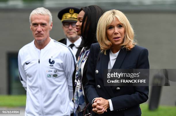 French president 's wife Brigitte Macron reacts flanked by French Sports Minister Laura Flessel and France's head coach Didier Deschamps during a...