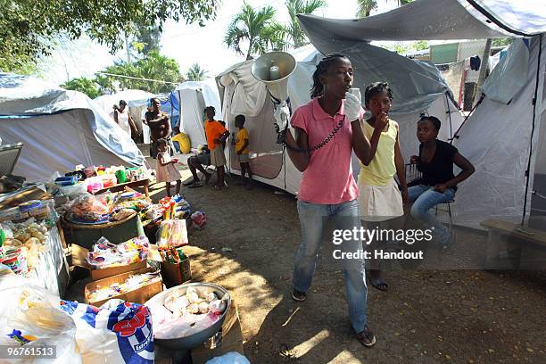 In this handout image provided by the United Nations Stabilization Mission in Haiti , Elvire Constant, goes tent by tent with a megaphone to tell...