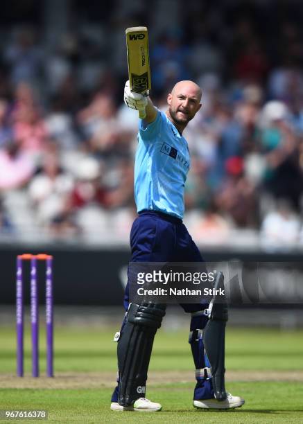 Adam Lyth of Yorkshire raises his bat after scoring 100 runs during the Royal London One Day Cup match between Lancashire and Yorkshire Vikings at...