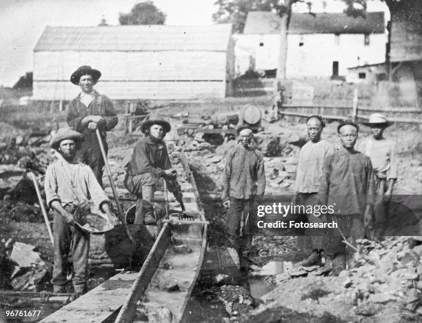 A group of white and Chinese gold miners at a sluice box, Aubine Ravine, California, 1852.
