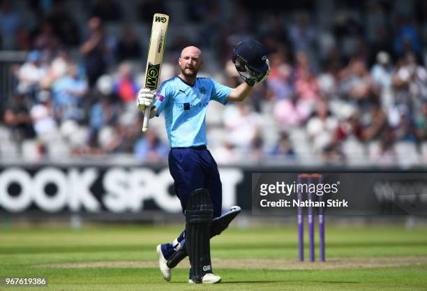 Adam Lyth of Yorkshire raises his bat after scoring 100 runs during the Royal London One Day Cup match between Lancashire and Yorkshire Vikings at...