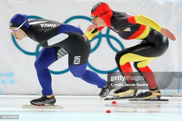 Lee Sang-Hwa of South Korea skates ahead of Jenny Wolf of Germany during the women's speed skating 500 m final on day five of the Vancouver 2010...