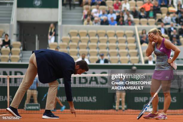 Russia's Yulia Putintseva looks on as the umpire points out a line call during her women's singles quarter-final match against Madison Keys of the US...