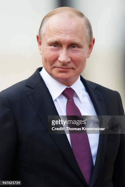 Russian President Vladimir Putin smiles after reviewing a guard of honor upon Putin's arrival at Hofburg palace on June 5, 2018 in Vienna, Austria....