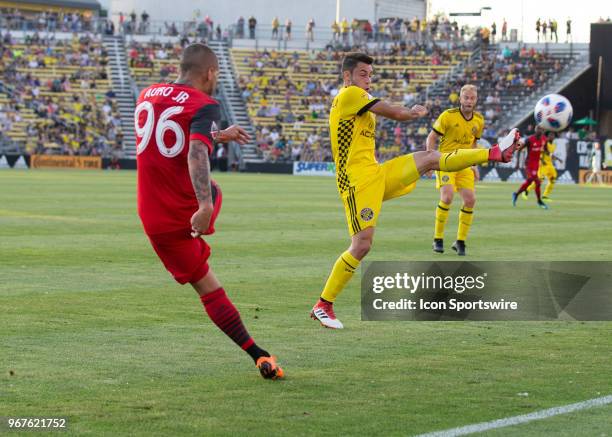 Auro of Toronto FCclears the ball past Milton Valenzuela of Columbus Crew SC during the game between the Columbus Crew SC and the Toronto FC at...