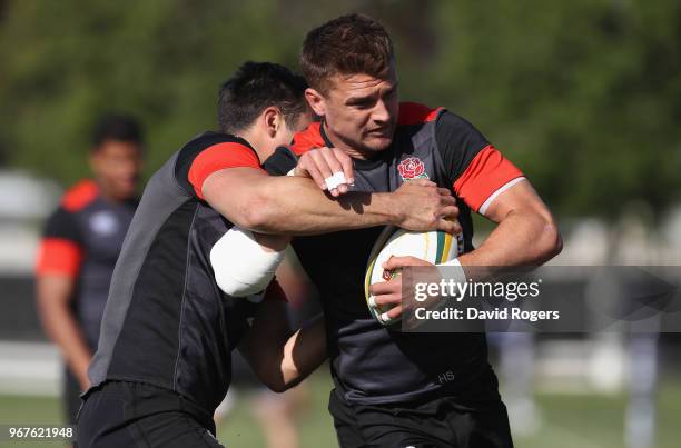 Henry Slade is tackled by Alex Lozowski during the England training session held at Kings Park Stadium on June 5, 2018 in Durban, South Africa.