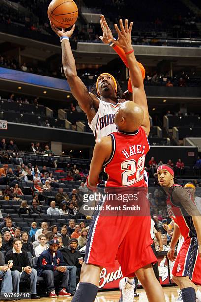 Jarvis Hayes of the New Jersey Nets blocks against Gerald Wallace of the Charlotte Bobcats on February 16, 2010 at the Time Warner Cable Arena in...
