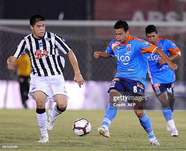 Bolivia's Blooming player Jose Luis Chavez vies for the ball with Paraguay's Libertad player Jorge Moeira during their Copa Libertadores football...